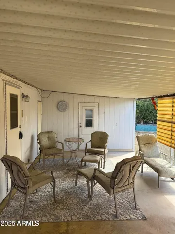 a kitchen with a refrigerator a sink dishwasher a stove and a dining table with wooden floor