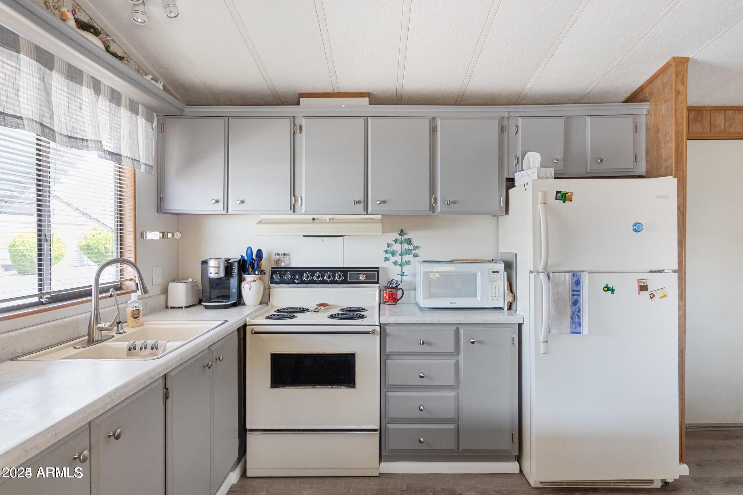 3330 East Main Street, Unit 9 Mesa, AZ 85213 - Photo 6 of 21 a kitchen with a white stove top oven sink and white refrigerator