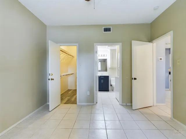 a view of a hallway with a bathroom and a sink