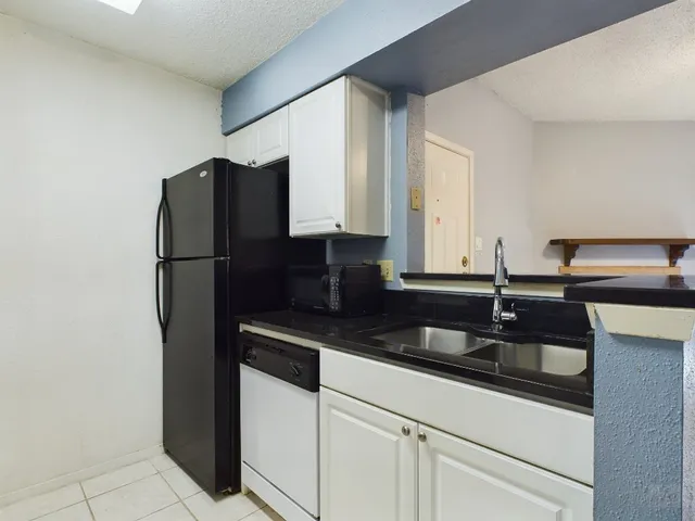 a kitchen with a sink and a refrigerator