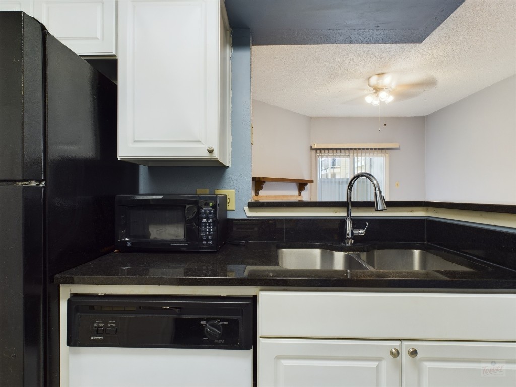 114 East 31st Street, Unit 113 Austin, TX 78705 - Photo 7 of 18 a kitchen with stainless steel appliances granite countertop a sink and a stove