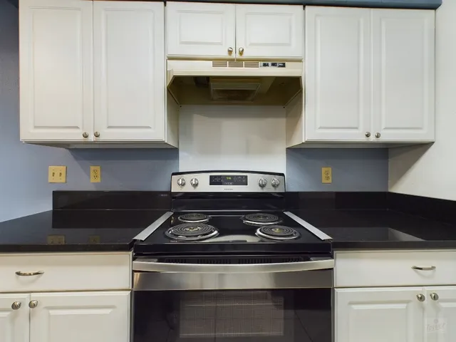 a stove top oven sitting inside of a kitchen