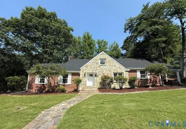 a front view of a house with a yard table and chairs