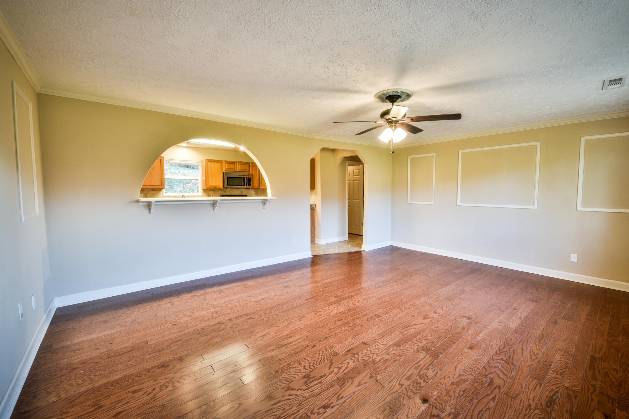 3984 Bent Road Kodak, TN 37764 - Photo 9 of 21 an empty room with a chandelier fan and windows