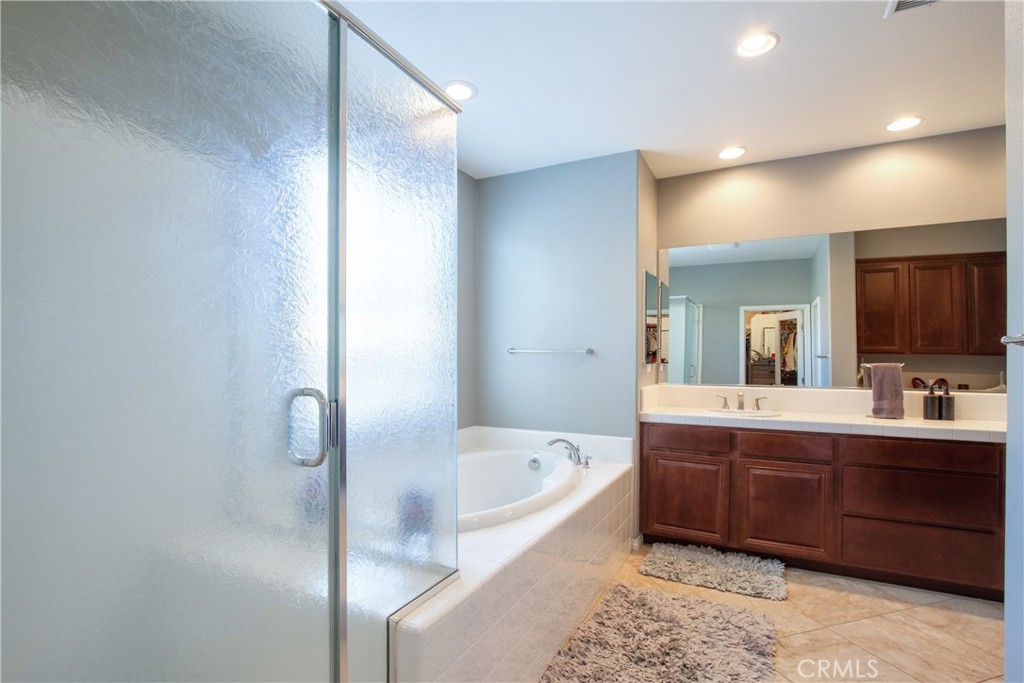 28483 Nautical Point Circle Menifee, CA 92585 - Photo 20 of 44 a bathroom with a bathtub and a double vanity sink