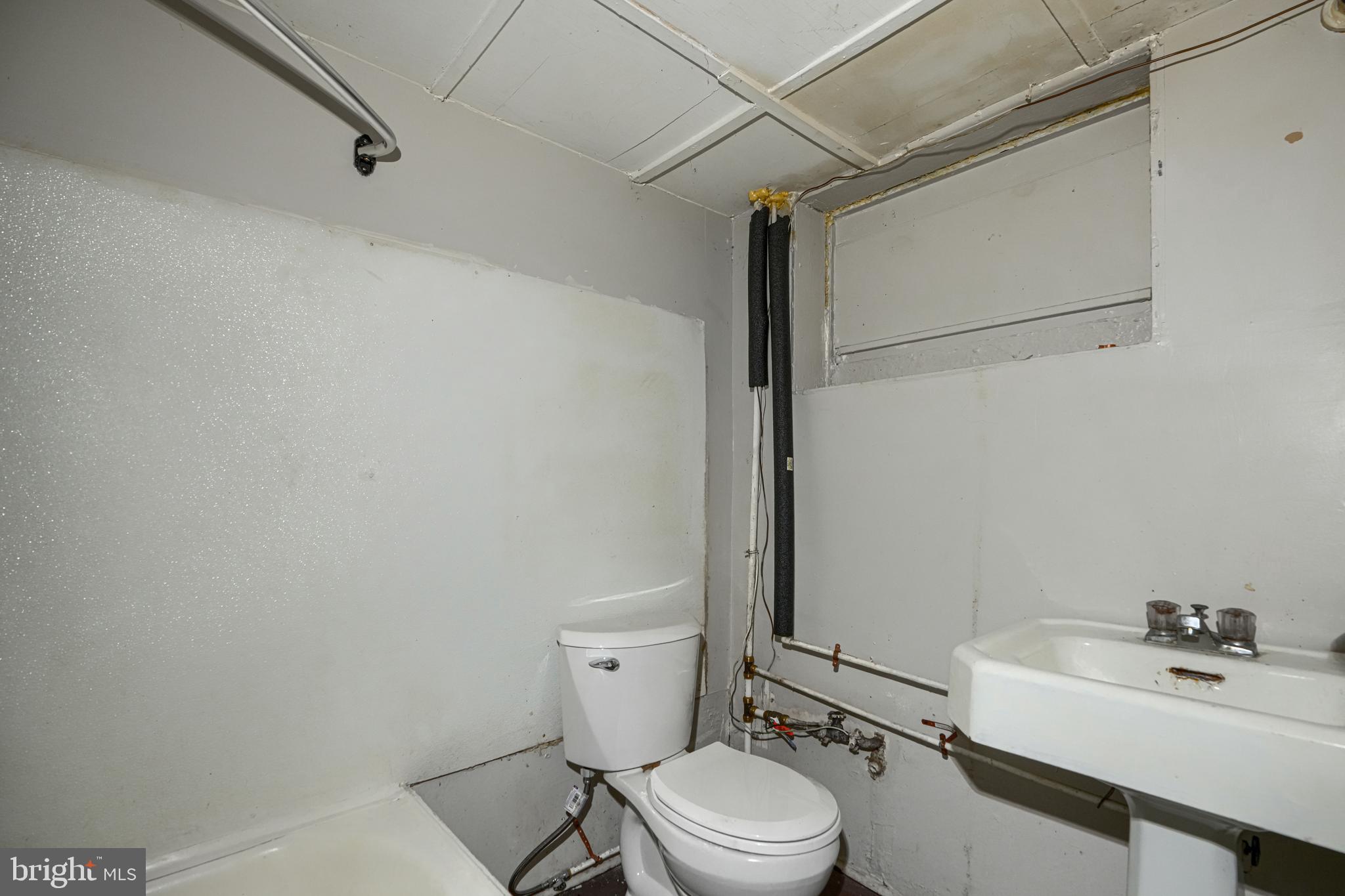 4806 Reisterstown Road Baltimore, MD 21215 - Photo 34 of 34 a white toilet sitting next to a bathroom sink