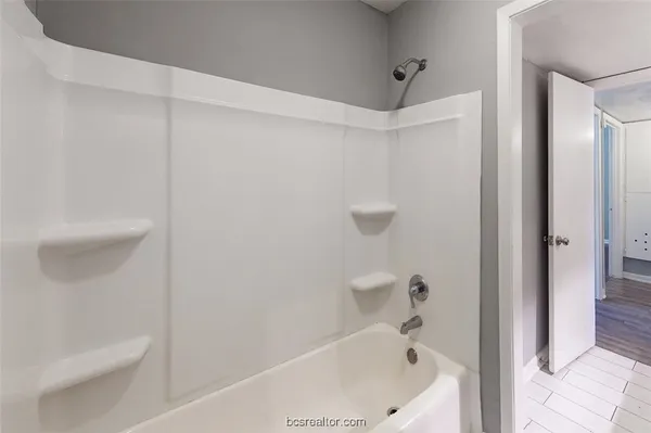 a bathroom with a bathtub and a toilet
