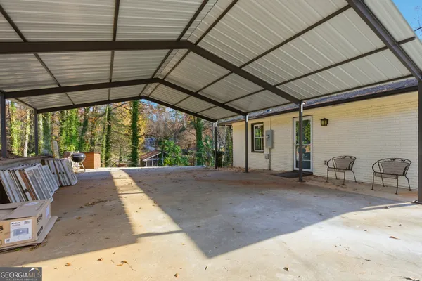 a backyard of a house with table and chairs