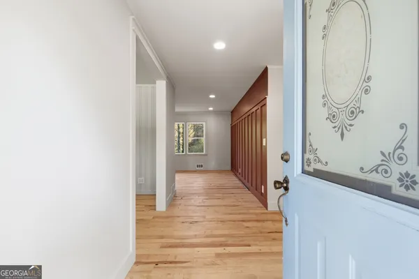 a view of a hallway with wooden floor