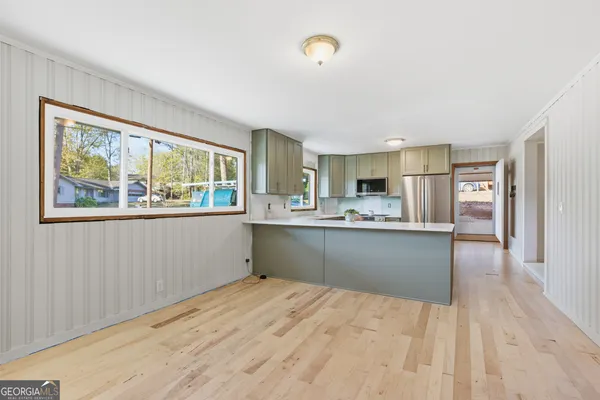 a kitchen with stainless steel appliances granite countertop a refrigerator sink and cabinets