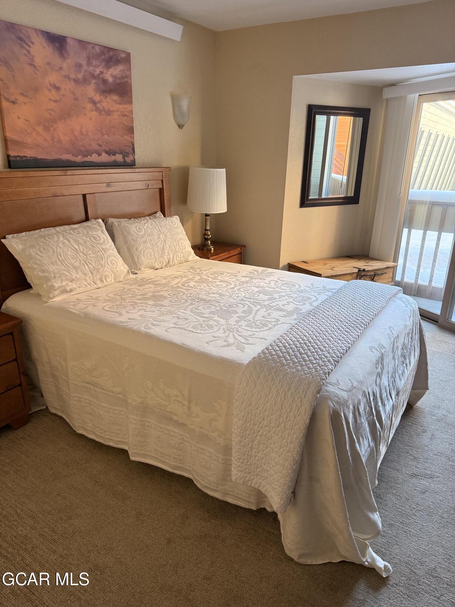 490 Kings Crossing Road, Unit 611 Winter Park, CO 80482 - Photo 19 of 39 a bedroom with a bed and wall painting