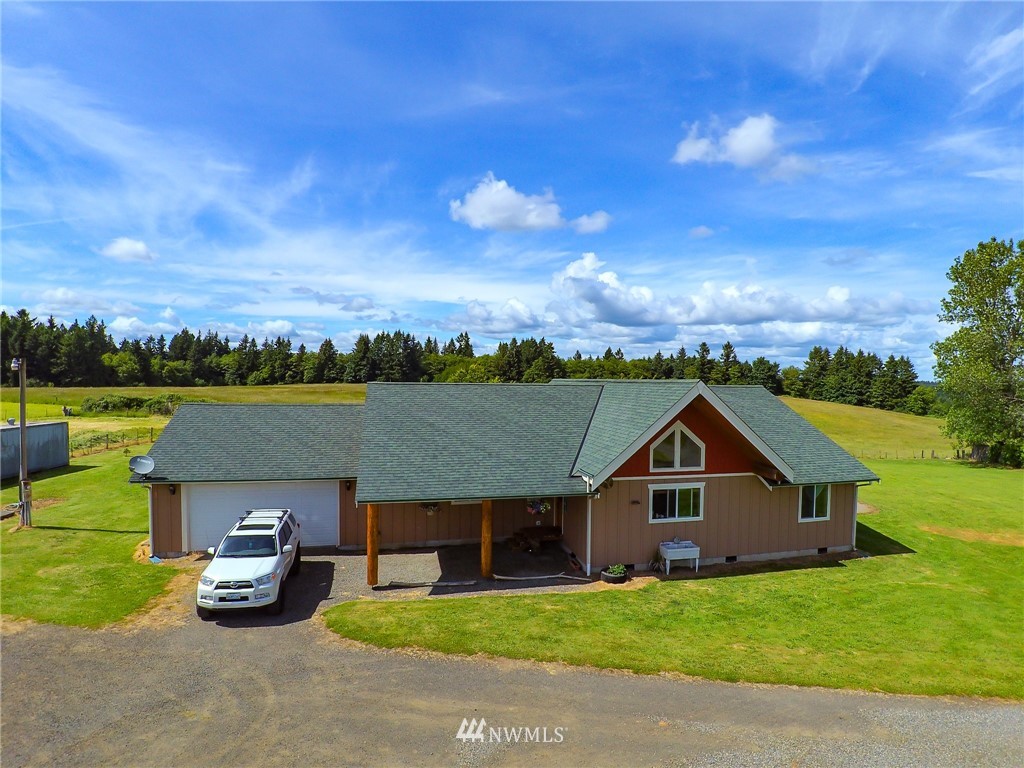 9302 Gastaeson Lane Southwest Rochester, WA 98579 - Photo 1 of 12 a front view of a house with a garden and lake view