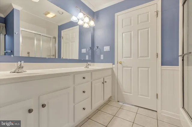 a spacious bathroom with double sink and mirror
