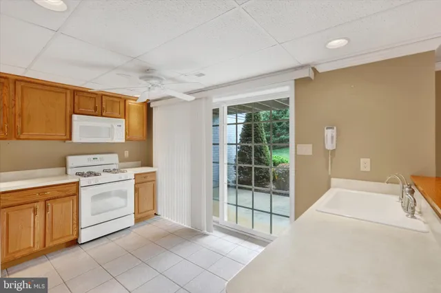 a kitchen with a stove a sink and a cabinets