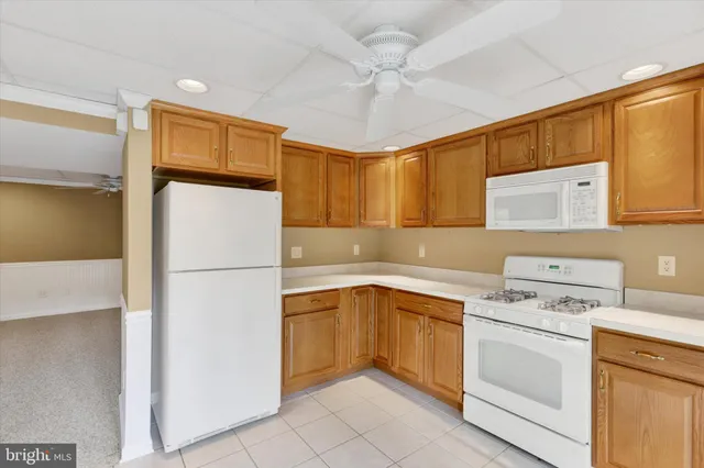 a kitchen with a white cabinets and white appliances