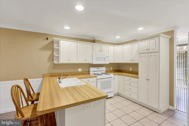 a kitchen that has a sink and a chair in it