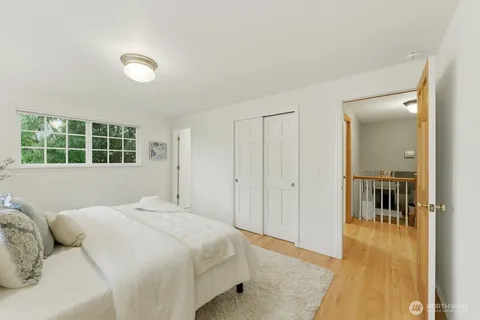 a bedroom with a bed and glass door