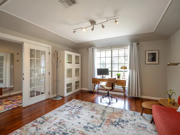 a living room with furniture and wooden floor
