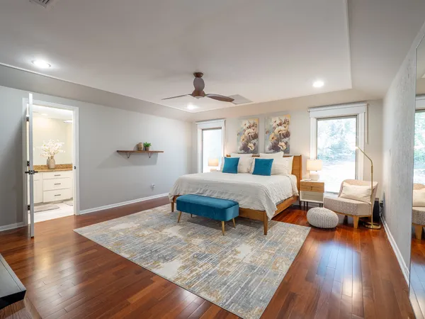 a bedroom with a bed and wooden floor
