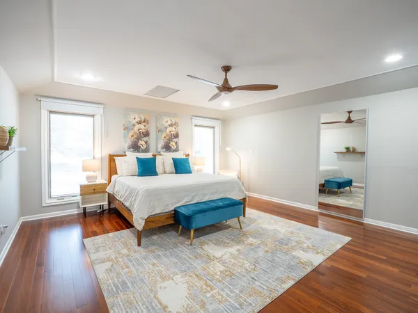 a bedroom with a bed and wooden floor