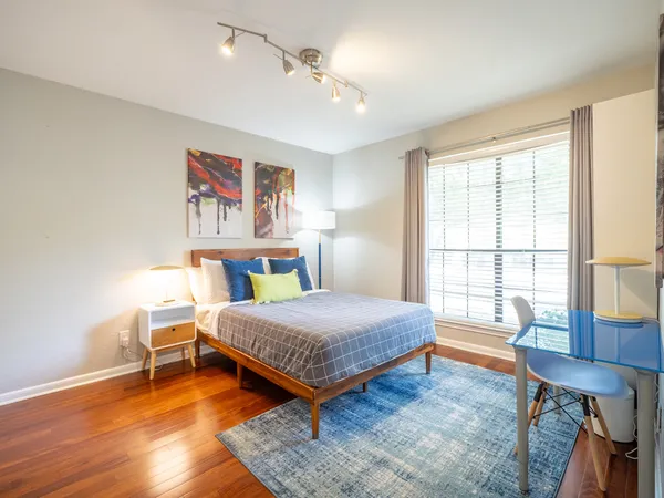 a bedroom with a bed and wooden floor