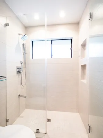 a bathroom with a shower and a bath tub