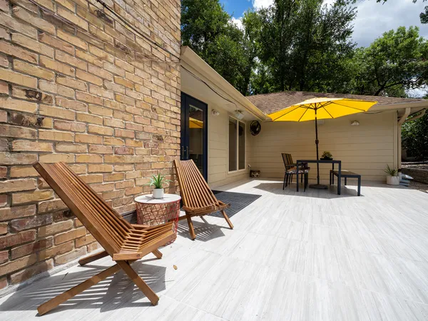 a view of a patio with chairs and tables