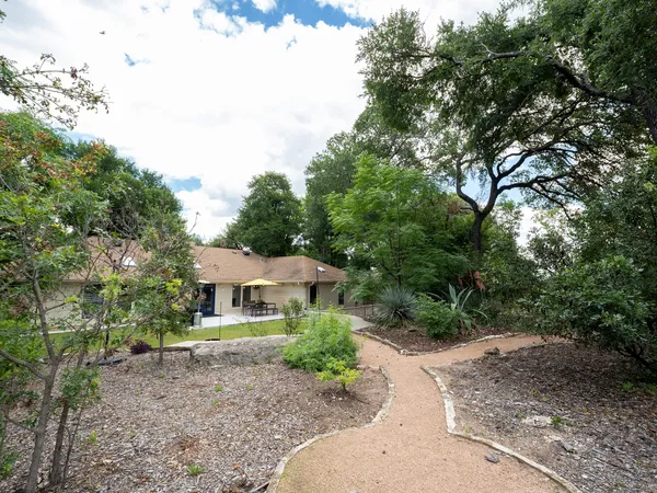a front view of a house with a garden
