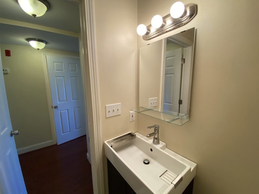 191 Everett Street, Unit 2 Boston, MA 02128 - Photo 5 of 6 a bathroom with a sink and a mirror