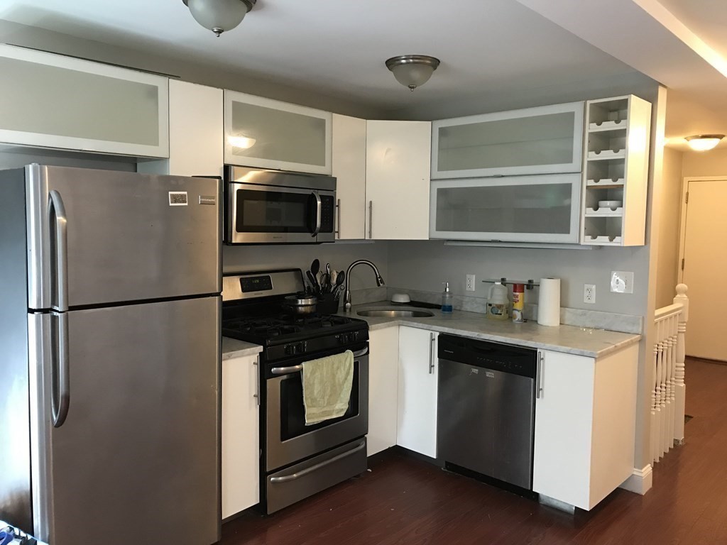 191 Everett Street, Unit 2 Boston, MA 02128 - Photo 6 of 6 a kitchen with stainless steel appliances a refrigerator sink and microwave