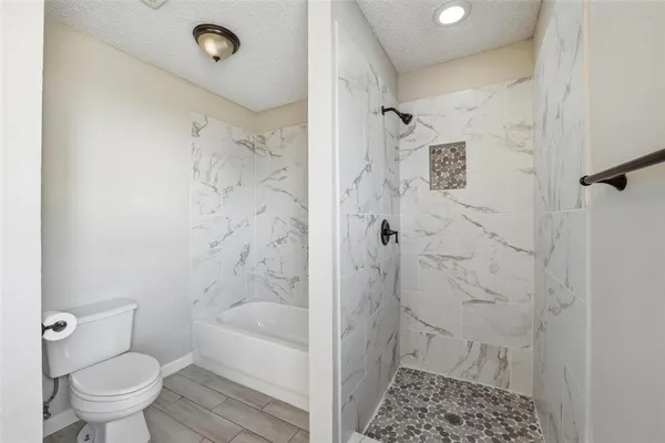 a bathroom with a shower and a toilet
