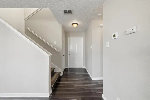 a view of a hallway with stairs