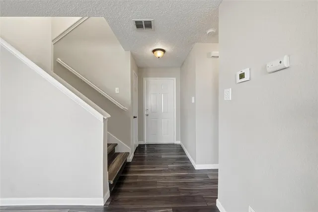 a view of a hallway with stairs