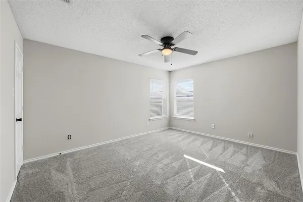 a view of room with a ceiling fan and hardwood floor