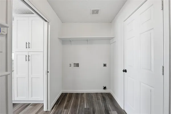 a view of a room with wooden floor