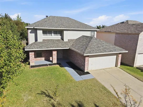 a front view of house with yard garage and seating