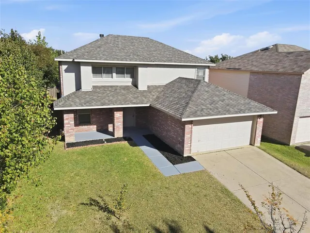 a front view of house with yard garage and seating