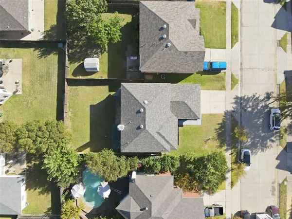 an aerial view of residential houses with outdoor space
