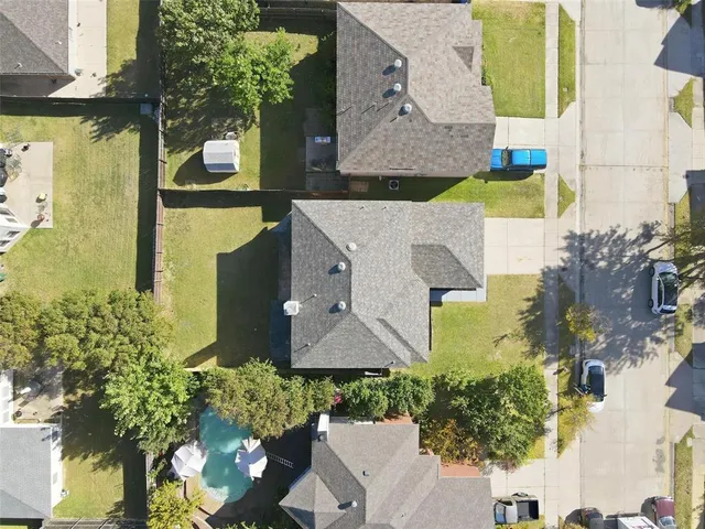 an aerial view of residential houses with outdoor space