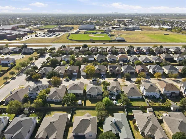 an aerial view of residential houses with outdoor space