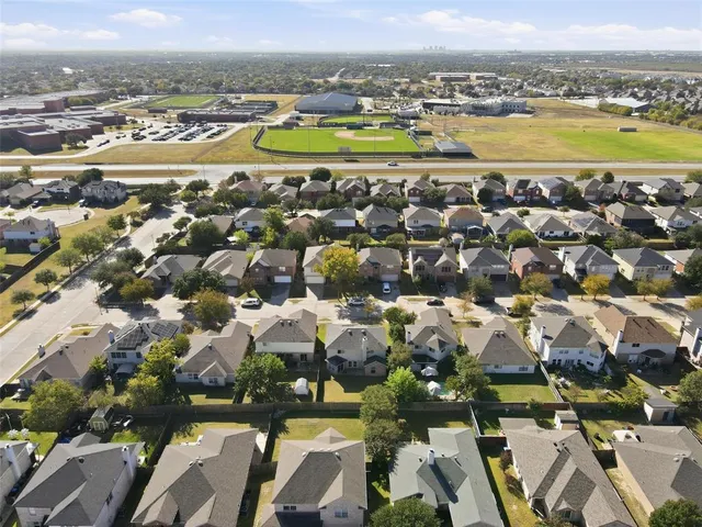 an aerial view of residential houses with outdoor space