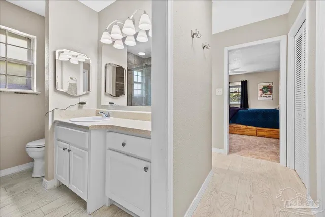 a spacious bathroom with a toilet sink and mirror