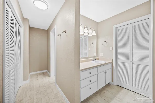 a bathroom with a double vanity sink and mirror with shower
