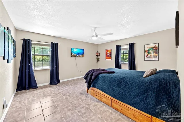 a bedroom with a bed and a flat tv screen