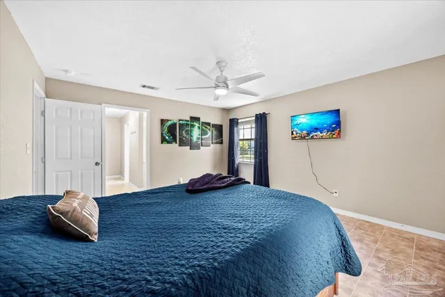 a bedroom with a bed and window