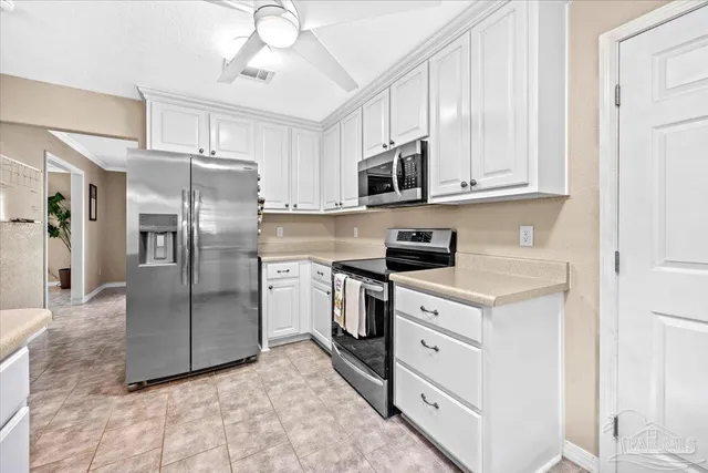 a kitchen with stainless steel appliances a refrigerator sink and microwave
