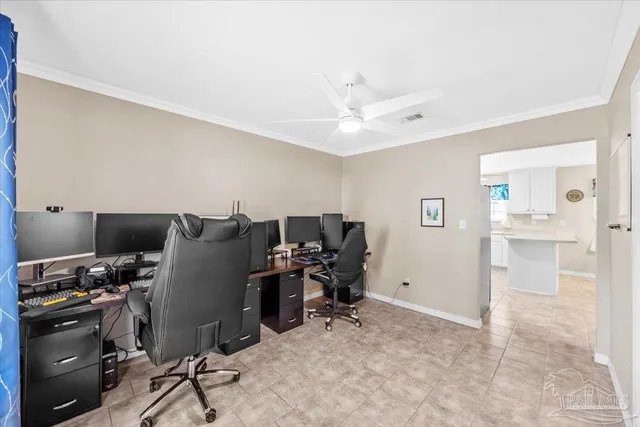 a view of a workspace with furniture and a window