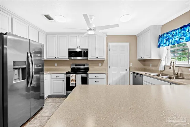 a kitchen with granite countertop a refrigerator stove and microwave