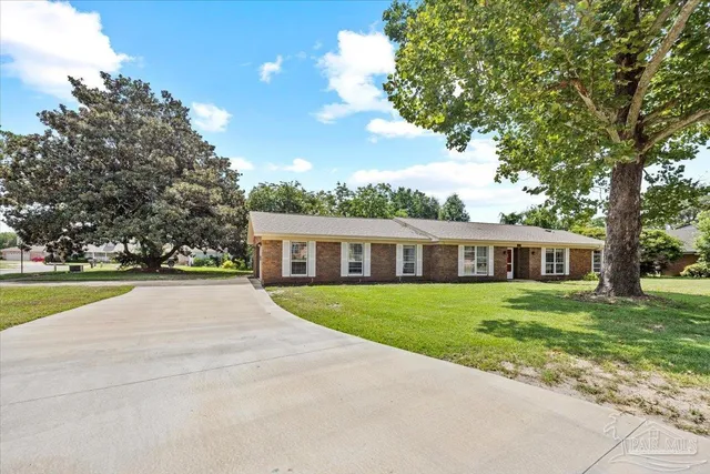 a view of house with outdoor space and tree s