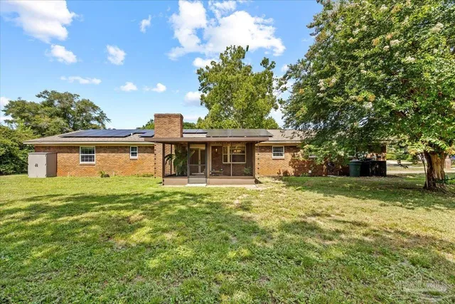 a front view of house with yard and green space